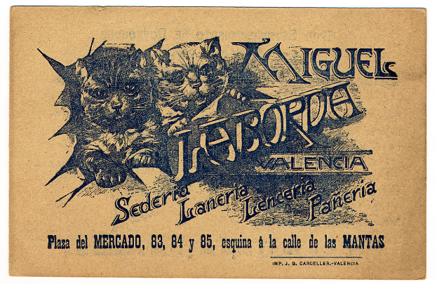 Ein altes Geschäftsblatt mit einem Foto von zwei Katzen, mit Text, der die Katzen beschreibt.