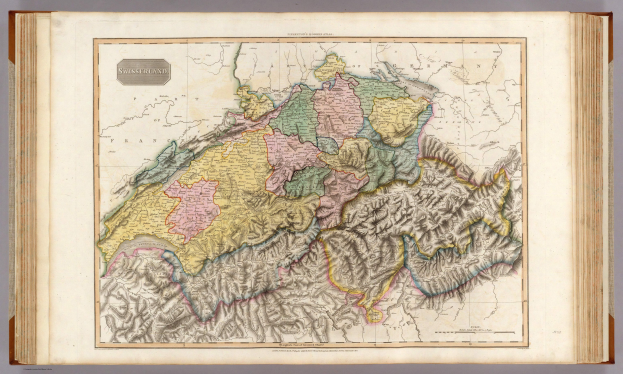 Ein altes Buch mit einer detaillierten Landkarte der Schweiz auf dem Cover, begleitet von erklärendem Text.